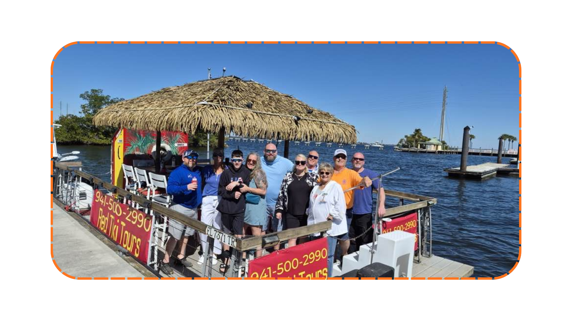 Group of people on a boat with a thatched roof docked by water.